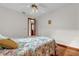 Bedroom with hardwood floors, ceiling fan and floral bedding at 3890 Waterview Loop, Winter Park, FL 32792