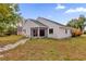 Pink house exterior with screened porch and stone pathway at 3890 Waterview Loop, Winter Park, FL 32792