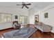 Bright living room with hardwood floors, a ceiling fan, and sliding glass doors at 3890 Waterview Loop, Winter Park, FL 32792