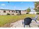 Large backyard with grassy area and patio seating at 4301 Lancashire Ln, Orlando, FL 32812