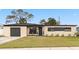 Updated ranch home with a modern facade, two-car garage, and well-manicured lawn at 4301 Lancashire Ln, Orlando, FL 32812