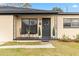 Inviting front porch with black metal chairs, perfect for relaxing at 4301 Lancashire Ln, Orlando, FL 32812