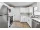 Modern kitchen with white cabinets, stainless steel appliances, and quartz countertops at 4301 Lancashire Ln, Orlando, FL 32812