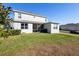 A spacious two-story home featuring a screened-in lanai and lush green lawn at 4485 Lions Gate Ave, Clermont, FL 34711