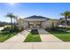 Beautiful community clubhouse entrance featuring stone pillars and a landscaped walkway at 4485 Lions Gate Ave, Clermont, FL 34711