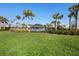 Community pool and clubhouse amidst lush landscaping and swaying palm trees at 4485 Lions Gate Ave, Clermont, FL 34711