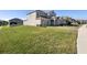 Well-manicured lawn leading to a spacious home with an attached garage at 4485 Lions Gate Ave, Clermont, FL 34711