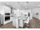 Well-lit kitchen featuring a large island with seating and modern stainless steel appliances at 4485 Lions Gate Ave, Clermont, FL 34711