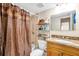 Bathroom with shower/tub combo, granite vanity and brown curtain at 4767 S Texas Ave # 4767C, Orlando, FL 32839