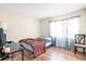 Bright bedroom with wood floors and window coverings at 4767 S Texas Ave # 4767C, Orlando, FL 32839