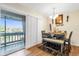 Dining area with table, bench, and sliding glass door leading to a balcony at 4767 S Texas Ave # 4767C, Orlando, FL 32839