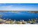 Aerial view of waterfront homes with lake access and city skyline in background at 5006 Monet Ave, Belle Isle, FL 32812