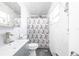 Clean bathroom with a gray vanity and patterned shower curtain at 5006 Monet Ave, Belle Isle, FL 32812