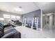 Comfortable living room with black leather sofas and a hallway view at 5006 Monet Ave, Belle Isle, FL 32812