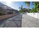 Large paved backyard with screened-in pool area at 5006 Monet Ave, Belle Isle, FL 32812