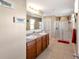 Main bathroom with double vanity and a walk-in shower at 6030 Forest Ridge Ln, Winter Haven, FL 33881