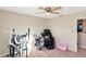 Bright bedroom with two twin beds, ceiling fan, and large window at 6030 Forest Ridge Ln, Winter Haven, FL 33881