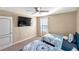 Well-lit bedroom featuring two twin beds and a large TV at 6030 Forest Ridge Ln, Winter Haven, FL 33881