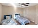 Bedroom with two twin beds, ceiling fan and window at 6030 Forest Ridge Ln, Winter Haven, FL 33881