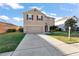 Two-story house with brown front door and attached garage at 6030 Forest Ridge Ln, Winter Haven, FL 33881