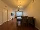 Dining area with hardwood floors and a chandelier at 6100 Stevenson Dr # 105, Orlando, FL 32835