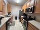 Galley-style kitchen with stainless steel appliances at 6100 Stevenson Dr # 105, Orlando, FL 32835