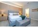 Modern bedroom with gray upholstered bed and wood accent wall at 6152 High Seas Dr, Orlando, FL 32821