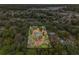 Aerial view showing home's location on a spacious lot with surrounding trees at 6514 Quarter Horse Ln, Orlando, FL 32818