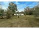 Single story home exterior, featuring a white exterior and large yard at 6514 Quarter Horse Ln, Orlando, FL 32818