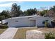 Newly renovated single story home with a paved driveway and landscaped yard at 660 Encino Way, Altamonte Springs, FL 32714