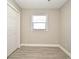 Bright bedroom with tile flooring, double door closet, and window with blinds at 660 Encino Way, Altamonte Springs, FL 32714