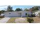 Newly renovated home featuring a paved driveway and tropical landscaping at 660 Encino Way, Altamonte Springs, FL 32714