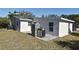 Rear view of house showcasing patio and grassy yard at 660 Encino Way, Altamonte Springs, FL 32714