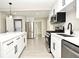 Modern kitchen with white cabinets, stainless steel appliances, and quartz countertop at 660 Encino Way, Altamonte Springs, FL 32714