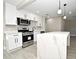 Modern kitchen with white cabinets, stainless steel appliances, and quartz countertop at 660 Encino Way, Altamonte Springs, FL 32714