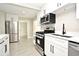 Modern kitchen with stainless steel appliances and white cabinets at 660 Encino Way, Altamonte Springs, FL 32714