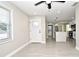 Living room with tile floors, white door, and view of kitchen at 660 Encino Way, Altamonte Springs, FL 32714