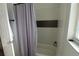 Simple bathroom with shower/tub combo and grey curtain at 7123 Yacht Basin Ave # 3, Orlando, FL 32835