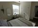 Bright bedroom features a large window, a closet, and a modern mirror at 7123 Yacht Basin Ave # 3, Orlando, FL 32835