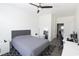 Bright bedroom featuring a ceiling fan, gray upholstered bed, and stylish décor, ideal for serene living at 7123 Yacht Basin Ave # 3, Orlando, FL 32835