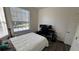 Bedroom with a bed, workspace, and large window at 7123 Yacht Basin Ave # 3, Orlando, FL 32835