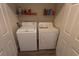 Cozy laundry area with a washer, dryer, and storage shelf at 7123 Yacht Basin Ave # 3, Orlando, FL 32835