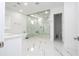 Spa-like bathroom with marble floors and a large shower at 717 Eastlawn Dr, Kissimmee, FL 34747