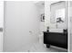 Contemporary powder room, featuring a sleek vanity and toilet at 717 Eastlawn Dr, Kissimmee, FL 34747