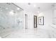 Luxury bathroom with a glass shower and marble details at 717 Eastlawn Dr, Kissimmee, FL 34747