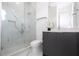 Modern bathroom with marble shower and gray vanity at 717 Eastlawn Dr, Kissimmee, FL 34747