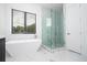 Modern bathroom with a large walk-in shower and soaking tub at 717 Eastlawn Dr, Kissimmee, FL 34747