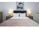 Elegant bedroom featuring a gray upholstered bed and nightstands at 717 Eastlawn Dr, Kissimmee, FL 34747