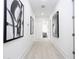 Bright hallway with light wood floors and framed art at 717 Eastlawn Dr, Kissimmee, FL 34747