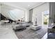 Elegant living room with gray sectional sofa and marble floors at 717 Eastlawn Dr, Kissimmee, FL 34747